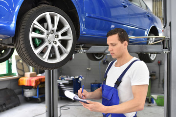 man in auto shop with car